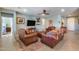 Comfortable living room showcasing leather furnishings, colorful rug, a TV, and a ceiling fan at 20194 N Riverbank Rd, Maricopa, AZ 85138