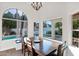 Dining room featuring a wood table, chandelier, and views of the pool at 2020 E Norwood St, Mesa, AZ 85213