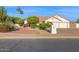 Charming single-story home with well-manicured landscaping, a three-car garage, and a cozy front patio at 2020 E Norwood St, Mesa, AZ 85213