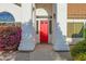 Inviting front entrance with a vibrant red door, elegant columns, and beautiful landscaping at 2020 E Norwood St, Mesa, AZ 85213