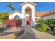 Inviting front entrance featuring a vibrant red door, elegant pillars, and well-maintained landscaping at 2020 E Norwood St, Mesa, AZ 85213