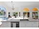 Bright kitchen with white cabinetry, island sink, and stunning views of the outdoor living spaces at 2020 E Norwood St, Mesa, AZ 85213