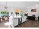 Open-concept living space with views from kitchen island to fireplace at 2020 E Norwood St, Mesa, AZ 85213