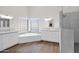 Bright, airy main bathroom featuring a large soaking tub, dual vanities, and a luxurious glass shower at 2020 E Norwood St, Mesa, AZ 85213