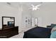 Serene main bedroom showcasing a large built-in shelf, ceiling fan, and cozy furnishings at 2020 E Norwood St, Mesa, AZ 85213