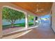 Expansive covered patio featuring a stained concrete floor and tongue-and-groove wood ceiling with ceiling fans at 2020 E Norwood St, Mesa, AZ 85213