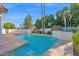 Inviting swimming pool with mature landscaping and a waterfall feature for a tranquil outdoor experience at 2020 E Norwood St, Mesa, AZ 85213