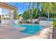 Serene pool area with a waterfall feature and lush landscaping, creating a private oasis at 2020 E Norwood St, Mesa, AZ 85213