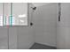 Modern bathroom showcasing a shower with gray tiles and a showerhead with a shelf for storage and a glass partition at 2020 E Norwood St, Mesa, AZ 85213