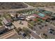 Aerial view of the community center with pools, tennis courts, and parking at 20392 W Brittlewood Ave, Buckeye, AZ 85396