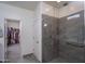 Modern bathroom showcasing large tiled shower with glass door and convenient grab bar at 20392 W Brittlewood Ave, Buckeye, AZ 85396