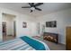 Spacious bedroom with neutral walls, carpet, ceiling fan, and door to outside at 20392 W Brittlewood Ave, Buckeye, AZ 85396