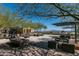 Serene courtyard with water feature, lounge seating, and shade umbrellas creating a resort-like feel at 20392 W Brittlewood Ave, Buckeye, AZ 85396