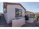 Exterior shot of the home with a brick-lined patio, grill, and manicured gravel at 20392 W Brittlewood Ave, Buckeye, AZ 85396