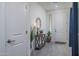 Welcoming foyer with decorative table, mirror, and elegant tiled flooring at 20392 W Brittlewood Ave, Buckeye, AZ 85396