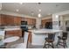 Bright kitchen featuring tile backsplash, a large island, stainless steel appliances, and ample cabinet space at 20392 W Brittlewood Ave, Buckeye, AZ 85396