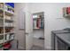 Well-organized laundry area with storage shelves leading to a convenient walk-in closet at 20392 W Brittlewood Ave, Buckeye, AZ 85396