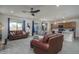 Open-concept living room featuring tile flooring, recessed lighting, and neutral walls and furnishings and a ceiling fan at 20392 W Brittlewood Ave, Buckeye, AZ 85396