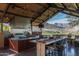 Outdoor kitchen with professional-grade appliances, dining area and mountain views at 20392 W Brittlewood Ave, Buckeye, AZ 85396