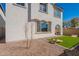 Backyard scene with artificial turf, cornhole game, desert rock landscaping, and white stucco wall at 2180 N Iowa St, Chandler, AZ 85225