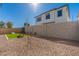 Wide view of the backyard showing the white stucco of the house and a cornhole setup on artificial turf at 2180 N Iowa St, Chandler, AZ 85225