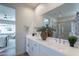 Bright bathroom featuring a double vanity, mirrors, and a glass shower for a clean and modern look at 2180 N Iowa St, Chandler, AZ 85225