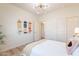 Bright bedroom featuring skateboards as wall art and a view into an adjacent hallway at 2180 N Iowa St, Chandler, AZ 85225