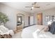 Stylish bedroom featuring hardwood floors, a ceiling fan, a bed, and windows for plenty of natural light and a mirror at 2180 N Iowa St, Chandler, AZ 85225