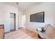 Modern bedroom with a wall-mounted television and access to closets and hallway at 2180 N Iowa St, Chandler, AZ 85225