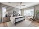 Cozy bedroom featuring hardwood floors, a ceiling fan, a bed, and windows for plenty of natural light at 2180 N Iowa St, Chandler, AZ 85225