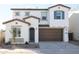 Charming two-story home featuring a two-car garage, dark blue shutters and decorative stone details at 2180 N Iowa St, Chandler, AZ 85225