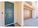 Up close view of the front door and the two car garage with a neutral color scheme at 2180 N Iowa St, Chandler, AZ 85225