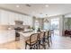 Modern kitchen with white cabinets, stainless steel appliances, island with seating and great natural light at 2180 N Iowa St, Chandler, AZ 85225