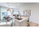 Kitchen island offers white quartz countertops, a stainless steel sink, and barstool seating at 2180 N Iowa St, Chandler, AZ 85225