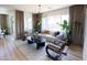 Bright living room with a neutral color palette, decorative plants, and a large window with natural light at 2180 N Iowa St, Chandler, AZ 85225