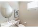 Stylish powder room features a modern sink, toilet, mirror, and vanity lighting at 2180 N Iowa St, Chandler, AZ 85225