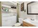 Functional bathroom with sink, toilet, laundry appliances, and shelving at 2233 W Farmdale Ave # 2, Mesa, AZ 85202