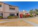 Inviting townhome with well-maintained desert landscaping and vibrant flowering bushes at 2233 W Farmdale Ave # 2, Mesa, AZ 85202