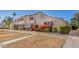 Attractive townhome featuring desert landscaping and colorful flowering bushes at 2233 W Farmdale Ave # 2, Mesa, AZ 85202