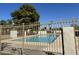 Community pool surrounded by a secure fence and mature landscaping at 2233 W Farmdale Ave # 2, Mesa, AZ 85202