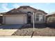 Charming single-story home with a two-car garage, desert landscaping, and an arched entryway at 2303 E Wescott Dr, Phoenix, AZ 85024