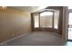 Spacious living room with neutral carpet, a bay window, and plenty of natural light at 2303 E Wescott Dr, Phoenix, AZ 85024