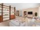 Open-concept living room featuring built-in shelving and neutral carpet at 2421 E Del Rio Dr, Tempe, AZ 85282