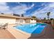 Backyard view with a sparkling swimming pool with blue skies in a fenced-in yard at 2421 E Del Rio Dr, Tempe, AZ 85282