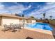 The backyard features a refreshing pool, patio, and mature palm trees at 2421 E Del Rio Dr, Tempe, AZ 85282