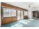 Cozy sunroom with wood paneling, lots of windows, and ceiling fan at 2421 E Del Rio Dr, Tempe, AZ 85282