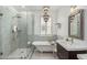 Elegant bathroom features a glass shower, soaking tub and decorative chandelier at 2701 E Hobart St, Gilbert, AZ 85296