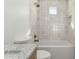 Modern bathroom featuring white tile, tub, and shower with marble countertop, perfect for relaxation at 2701 E Hobart St, Gilbert, AZ 85296