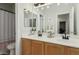 Bright bathroom featuring double vanity sinks and a shower with a gray curtain at 2701 E Hobart St, Gilbert, AZ 85296