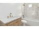 Bright bathroom with marble countertops, wooden cabinets, and a tiled shower-tub combo at 2701 E Hobart St, Gilbert, AZ 85296